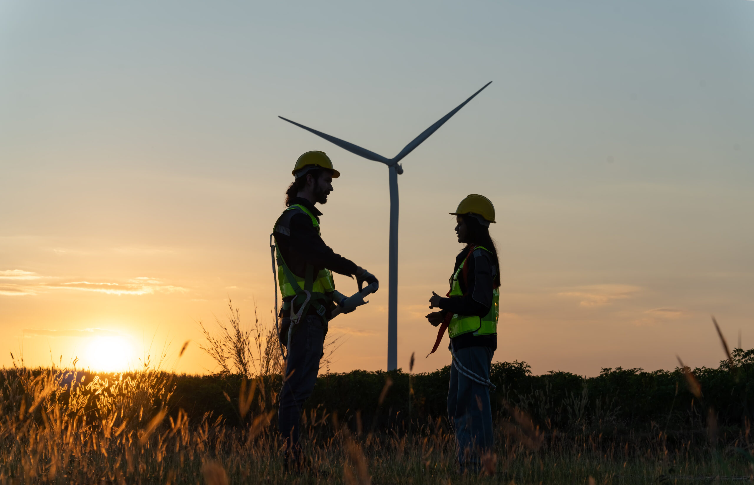 multiracial-colleagues-examining-wind-turbines-blu-2024-01-05-20-19-59-utc-scaled.jpg