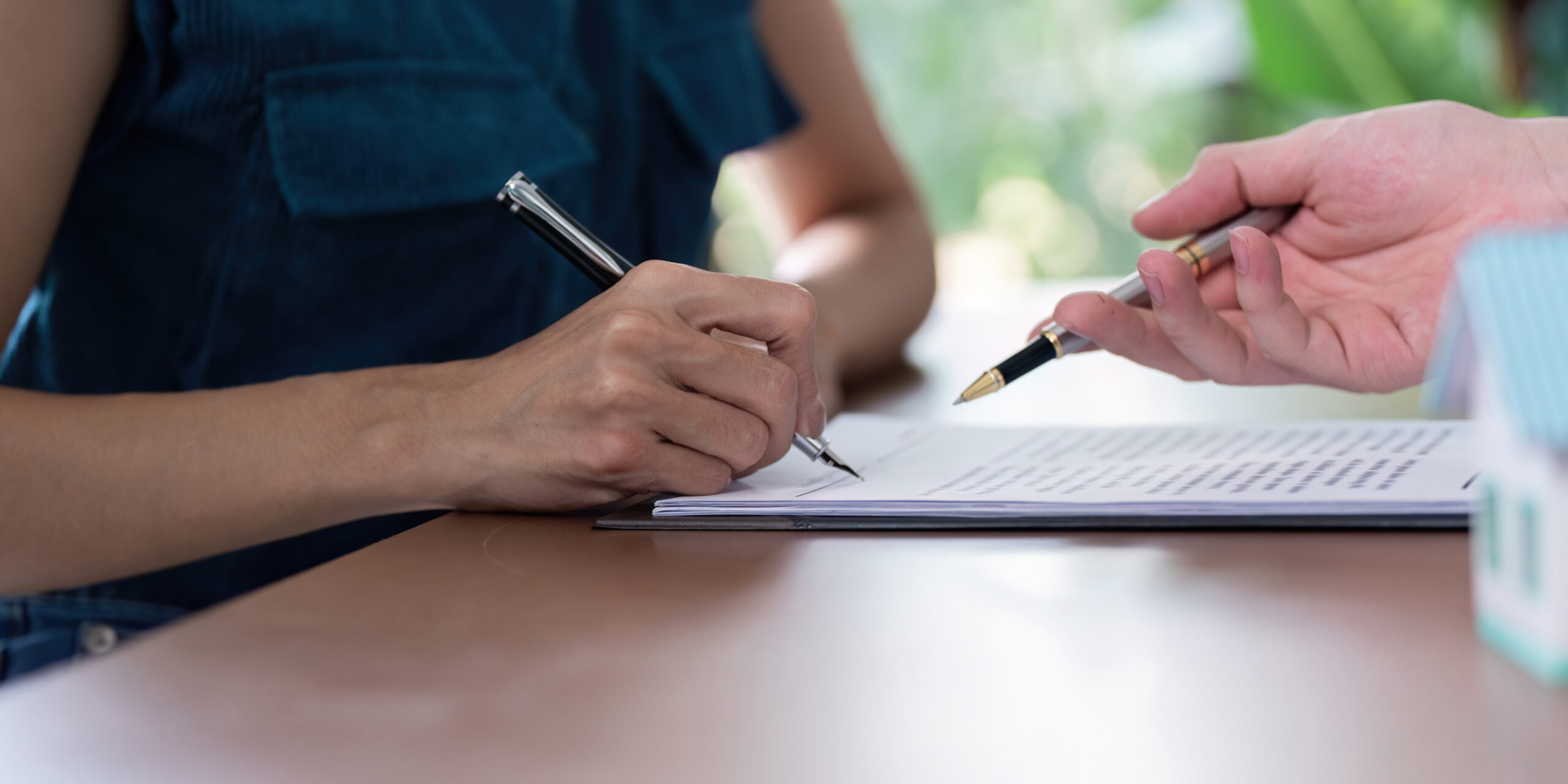 close-up-signing-a-real-estate-purchase-agreement-2025-01-10-12-51-55-utc-scaled.jpg