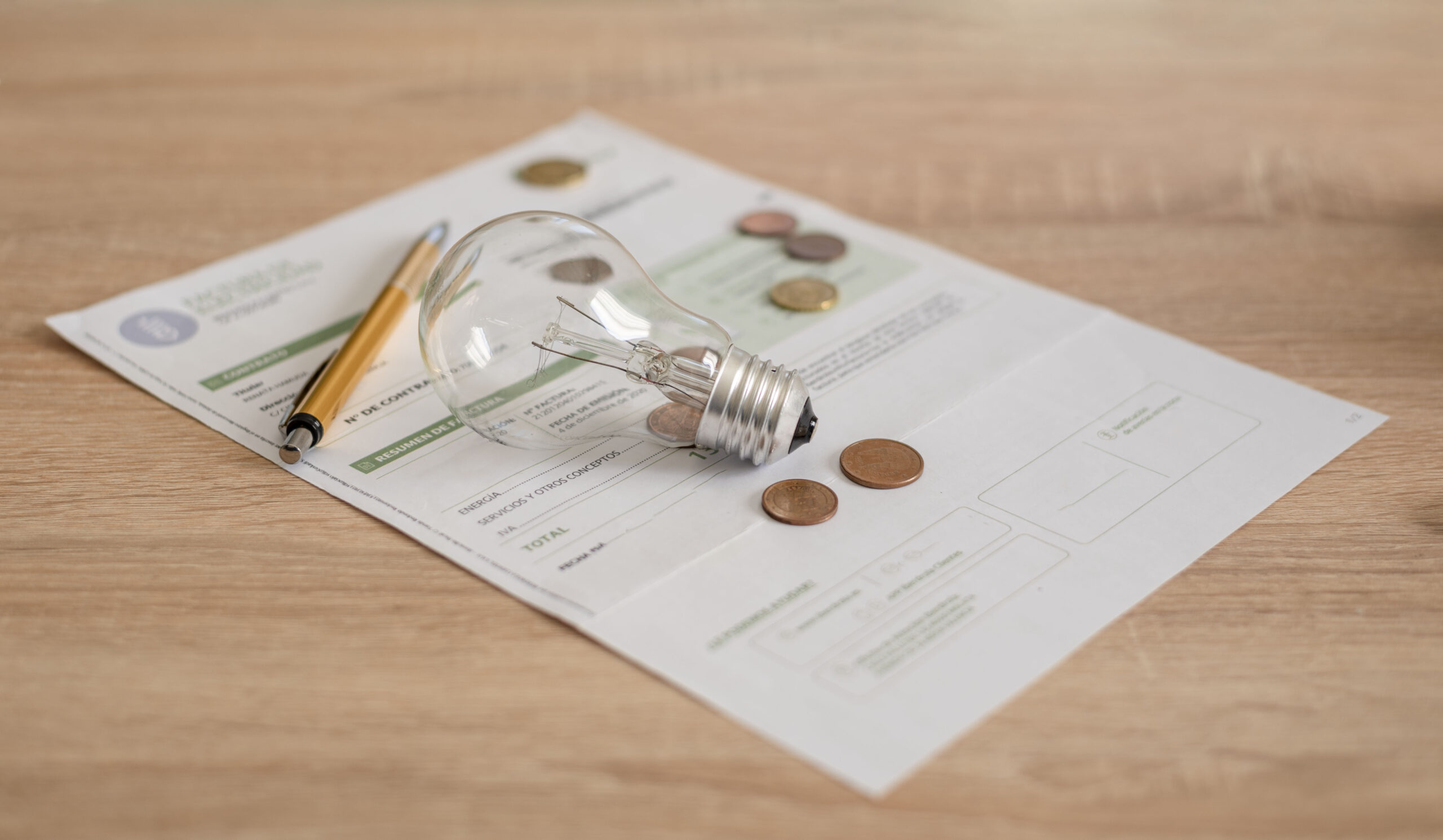 electricity-bill-with-light-bulb-several-coins-an-2023-11-27-05-32-09-utc-scaled.jpg